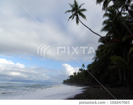 waves lap on remote dark sand beach waves lap on remote dark sand beach 108847065