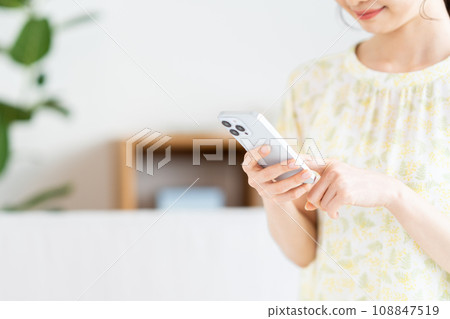正在操作智慧型手機的女士。 正在操作智慧型手機的女士。 108847519