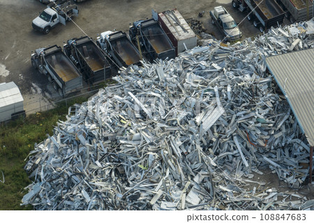 Beg pile of scrap aluminum metal siding from ruined houses after hurricane Ian swept through Florida. Recycle of broken parts of mobile homes Beg pile of scrap aluminum metal siding from ruined houses after hurricane Ian swept through Florida. Recycle of broken parts of mobile homes 108847683