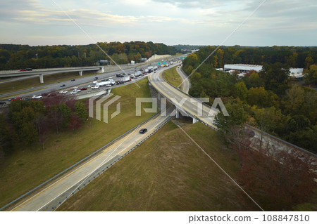 American freeway intersection with fast driving cars and trucks. View from above of USA transportation infrastructure 108847810