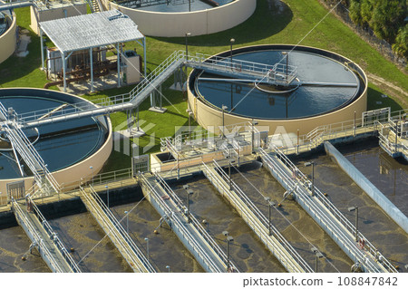 Aerial view of water treatment factory at city wastewater cleaning facility. Purification process of removing undesirable chemicals, suspended solids and gases from contaminated liquid Aerial view of water treatment factory at city wastewater cleaning facility. Purification process of removing undesirable chemicals, suspended solids and gases from contaminated liquid 108847842