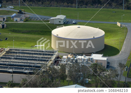 Aerial view of modern water cleaning facility at urban wastewater treatment plant. Purification process of removing undesirable chemicals, suspended solids and gases from contaminated liquid Aerial view of modern water cleaning facility at urban wastewater treatment plant. Purification process of removing undesirable chemicals, suspended solids and gases from contaminated liquid 108848210