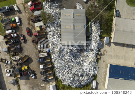 Aerial view of large pile of scrap aluminum metal from broken houses after hurricane Ian swept through Florida. Recycle of broken parts of mobile homes 108848243
