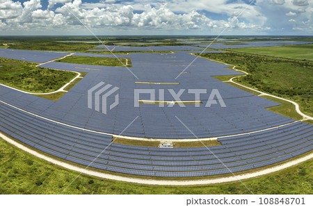 Aerial view of big sustainable electric power plant with many rows of solar photovoltaic panels for producing clean electrical energy. Renewable electricity with zero emission concept Aerial view of big sustainable electric power plant with many rows of solar photovoltaic panels for producing clean electrical energy. Renewable electricity with zero emission concept 108848701