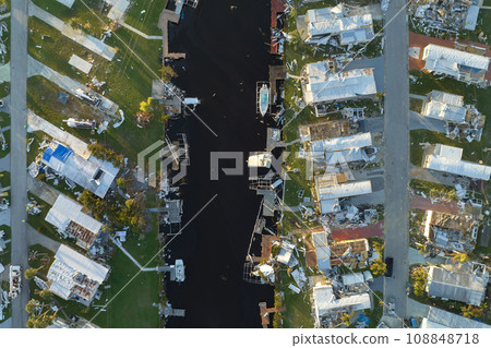 Aerial view of badly damaged mobile homes after hurricane Ian swept through residential area in Florida. Aftermath of natural disaster Aerial view of badly damaged mobile homes after hurricane Ian swept through residential area in Florida. Aftermath of natural disaster 108848718