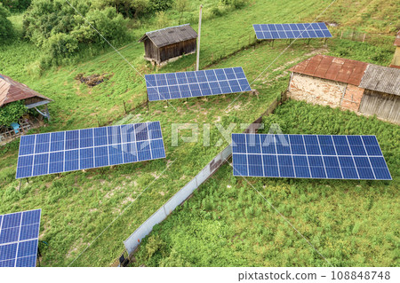 Aerial top down view of solar panels in green rural area. 108848748