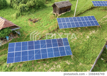 Aerial top down view of solar panels in green rural area. 108848749