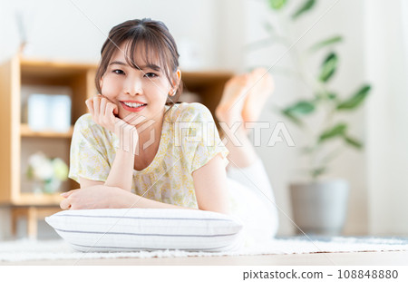 A woman relaxing in the living room. 108848880