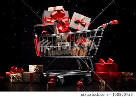 A black Friday Sale concept - black present boxes with red ribbons in shopping cart on a black background 108850726