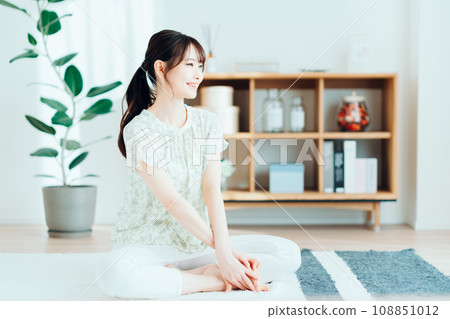 A woman relaxing in the living room. 108851012