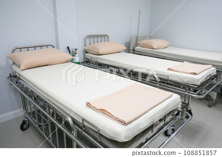 Recovery Room with bed and comfortable medical equipped in a hospital. Mattress with white cloth Recovery Room with bed and comfortable medical equipped in a hospital. Mattress with white cloth 108851857