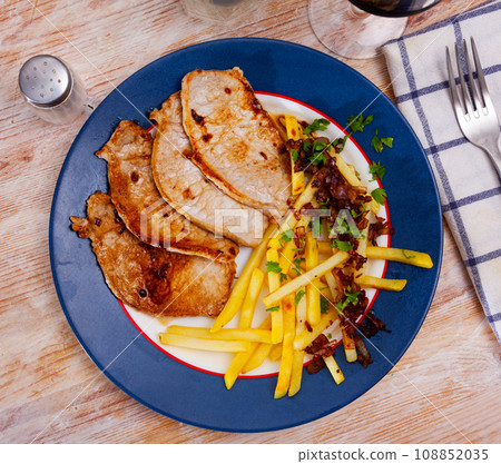Roasted pork loin with French fries and fresh herbs Roasted pork loin with French fries and fresh herbs 108852035