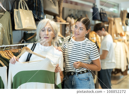 Two women choosing convenient jumper in clothing store 108852272
