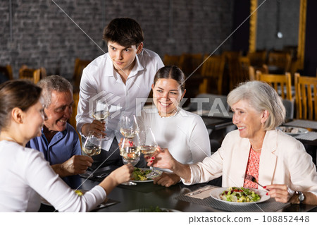 Large family, company of spouses in restaurant, eat, celebrate important event, communicate. 108852448