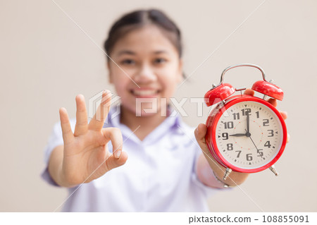 Teen girl student with alarm time clock for ready education times back to school concept happy smile. 108855091