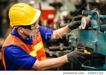 Engineer milling technician male worker Asian chinese manual hand skill working in heavy industry control metal lathe machine 108855102