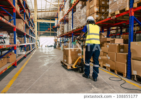african black warehouse worker using parcel pallet moving cargo for logistics shipping supply management industry 108855177