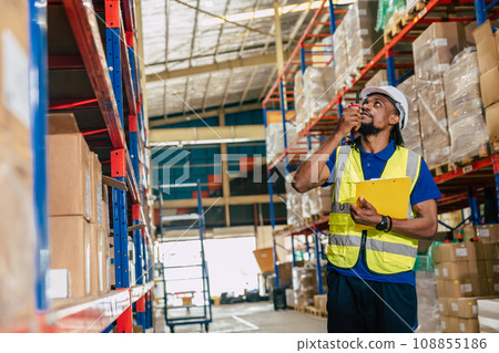 warehouse african black male worker. inventory clerk staff working radio control loading check remaining products in stock. 108855186