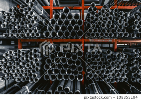 Metal pipes connector tubes. Construction cylindrical steel pipe stacked valious size in construction equipment store shelf. 108855194