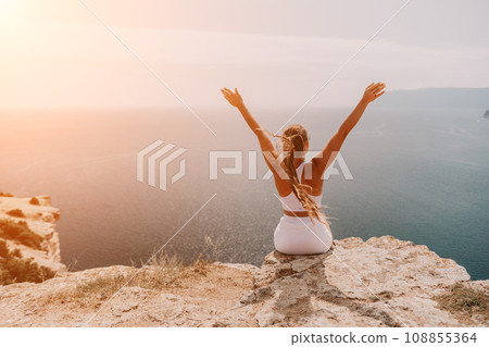 Woman sea pilates. Sporty middle-aged woman training in pilates on yoga mat by sea. concepts of health, wellness, and mindfulness in exercise, promoting the benefits of active and balanced lifestyle 108855364