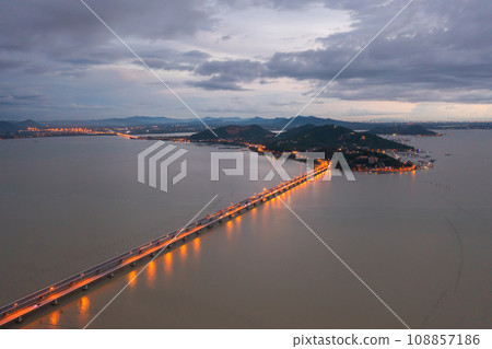Aerial top view of a bridge with garden park with green mangrove forest trees, river, pond or lake. Nature landscape background, Thailand. Aerial top view of a bridge with garden park with green mangrove forest trees, river, pond or lake. Nature landscape background, Thailand. 108857186