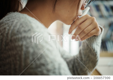 Asian student woman read books in library at university. Young girl stress tired have problem while study hard. Sadness concept 108857300