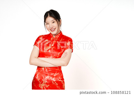 Asian woman wearing traditional cheongsam qipao dress with gesture standing and looking forward with arms crossed on white background. Happy Chinese new year. 108858121