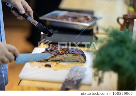 Chef seasoning a dish in the kitchen Chef seasoning a dish in the kitchen 108859063