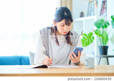Young woman checking advertisements Young woman checking advertisements 108860430