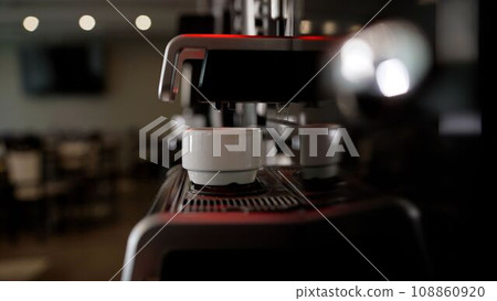 Americano preparation process. Espresso from a coffee machine. Coffee machine at the hotel buffet. Coffee machines make coffee without people. The coffee machine pours coffee into a glass. 108860920
