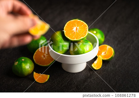 close up of woman hands holding bowl with fruits 108861278