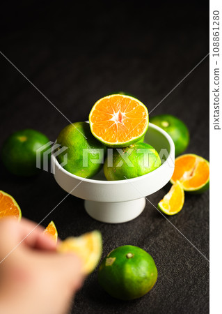 close up of woman hands holding bowl with fruits 108861280