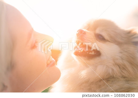 Close up portrait of smiling young attractive woman embracing spitz. Close up portrait of smiling young attractive woman embracing spitz. 108862030