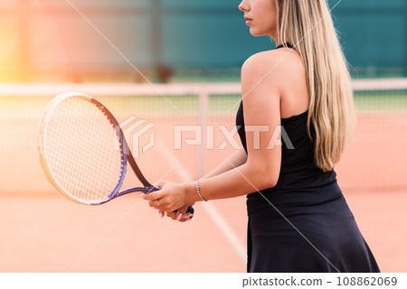 Tennis tournament. Female player at the clay tennis court Tennis tournament. Female player at the clay tennis court 108862069
