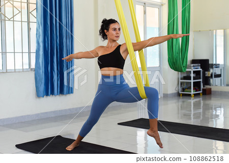 Young woman making aerial or fly yoga pose Warrior 108862518