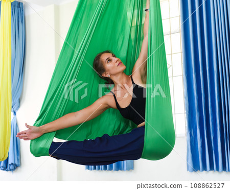 Young woman making aerial or fly yoga pose Young woman making aerial or fly yoga pose 108862527
