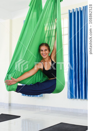 Young woman making aerial or fly yoga pose Young woman making aerial or fly yoga pose 108862528
