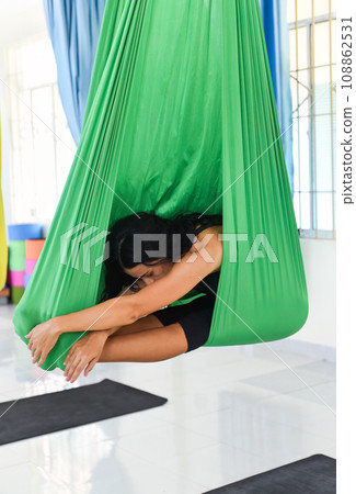 Young woman making aerial or fly yoga pose Young woman making aerial or fly yoga pose 108862531