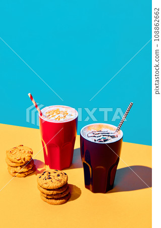 Cups with delicious, sweet hot drinks, cocoa, coffee, hot chocolate with whipped cream against yellow blue background. Poster 108862662