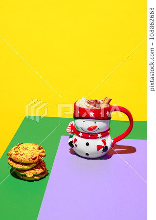 Mug in image of snowman filled with delicious hot drink, cocoa, coffee with whipped cream and cinnamon over colorful background. Poster 108862663