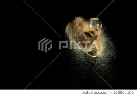 Hourglass fly in mid air, add more sand of time on gold sand over black background. Brown hourglass show more time Deadline extended time management hope concept hour glass, life clock passing by Hourglass fly in mid air, add more sand of time on gold sand over black background. Brown hourglass show more time Deadline extended time management hope concept hour glass, life clock passing by 108863166
