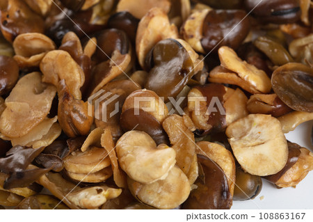 Pile of Salt Broad Beans, broad bean fall down pour on ground. Tropical Salty roasted broad bean shot close up. White background Isolated 108863167