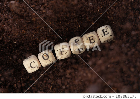 Coffee alphabet letter word bead fly with powder seed. Coffee roasted concept to refresh morning work. Coffee mix bean dust powder, alphabet letter word concept. Black background isolated 108863173