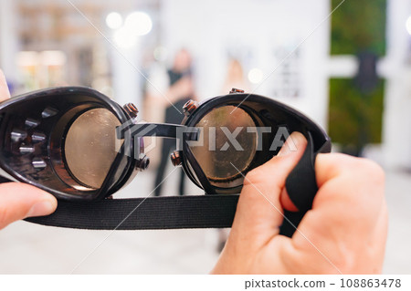 Welding goggles in hand. Welding goggles in hand. 108863478