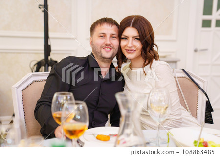 A married couple at a table in a restaurant. A married couple at a table in a restaurant. 108863485