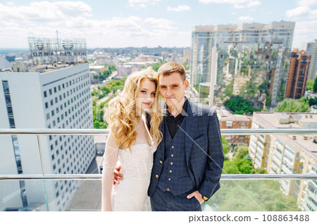 Happy bride and groom on the terrace of a multi-storey hotel. Happy bride and groom on the terrace of a multi-storey hotel. 108863488