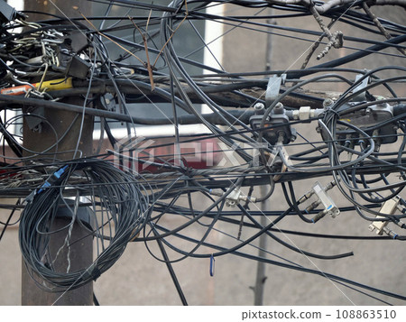 Mexico City Messed up power lines and connection cables. Many tangled wires on electric poles in the city Mexico City Messed up power lines and connection cables. Many tangled wires on electric poles in the city 108863510