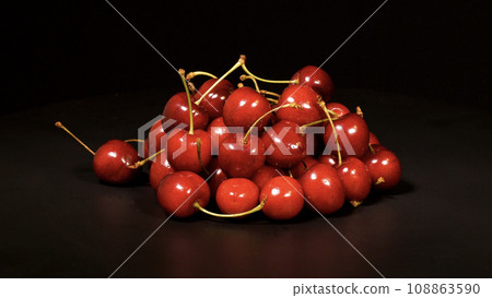 Close-up footage of cherry fruit on black background. Close-up footage of cherry fruit on black background. 108863590
