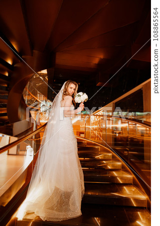 Bride on a golden spiral staircase. Bride on a golden spiral staircase. 108865564