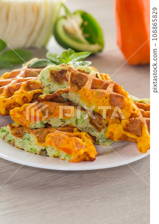 cooked two-color vegetable waffles made from cabbage and carrots. 108865829